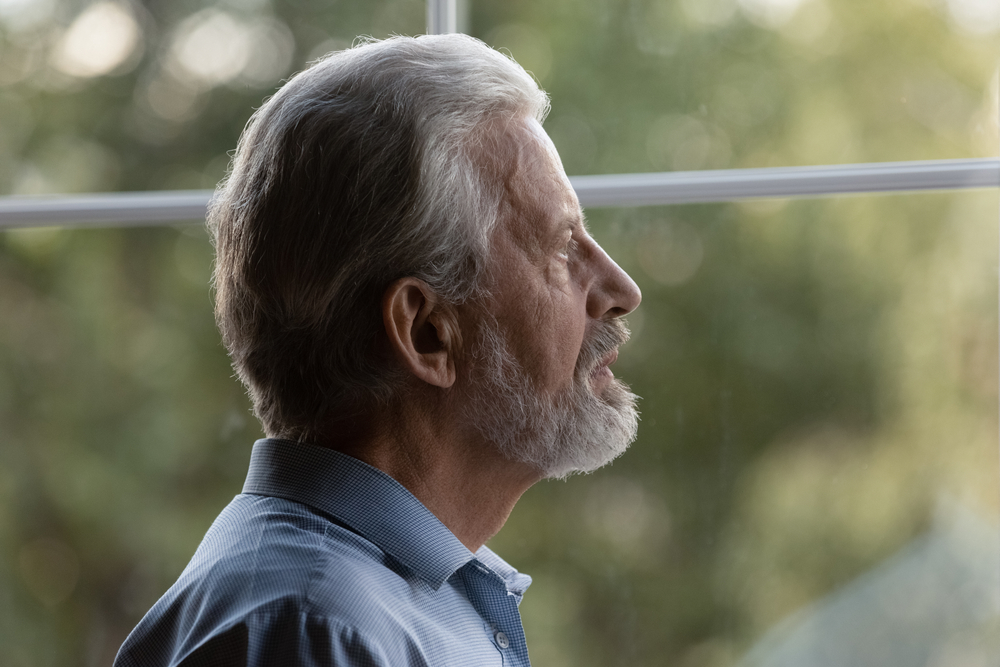 Older man looking out the window