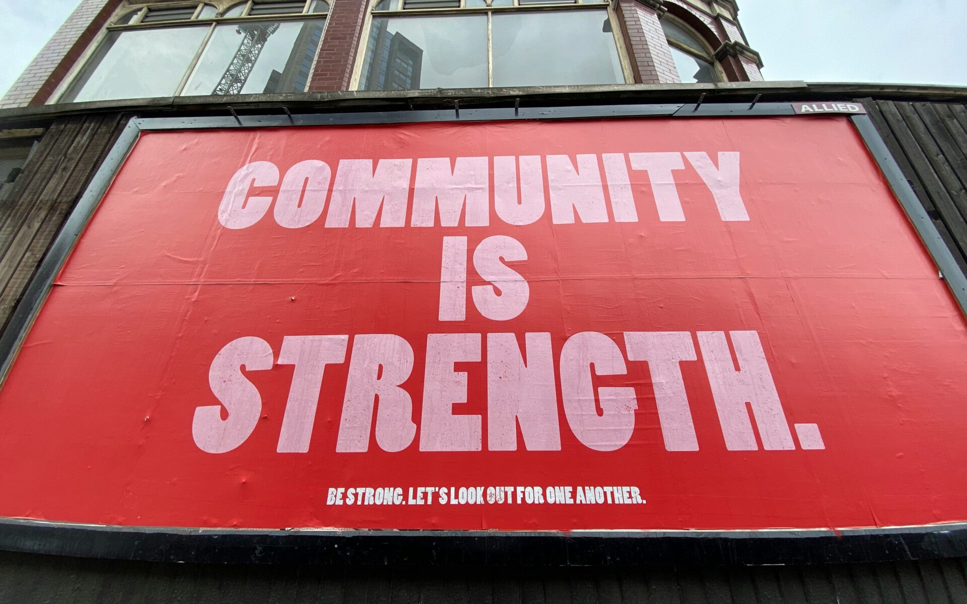A sign reads community is strength