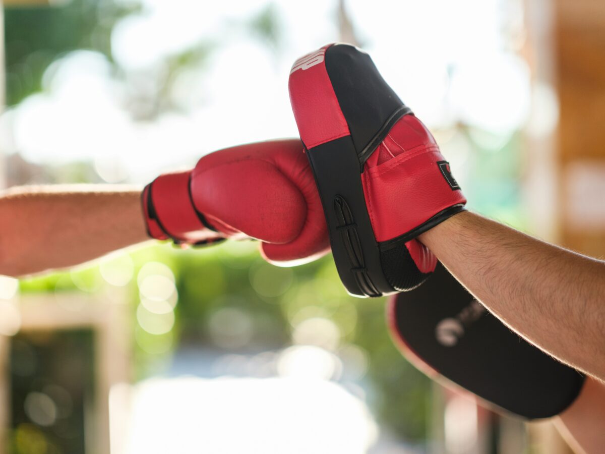 Boxing gloved hand punches a pad
